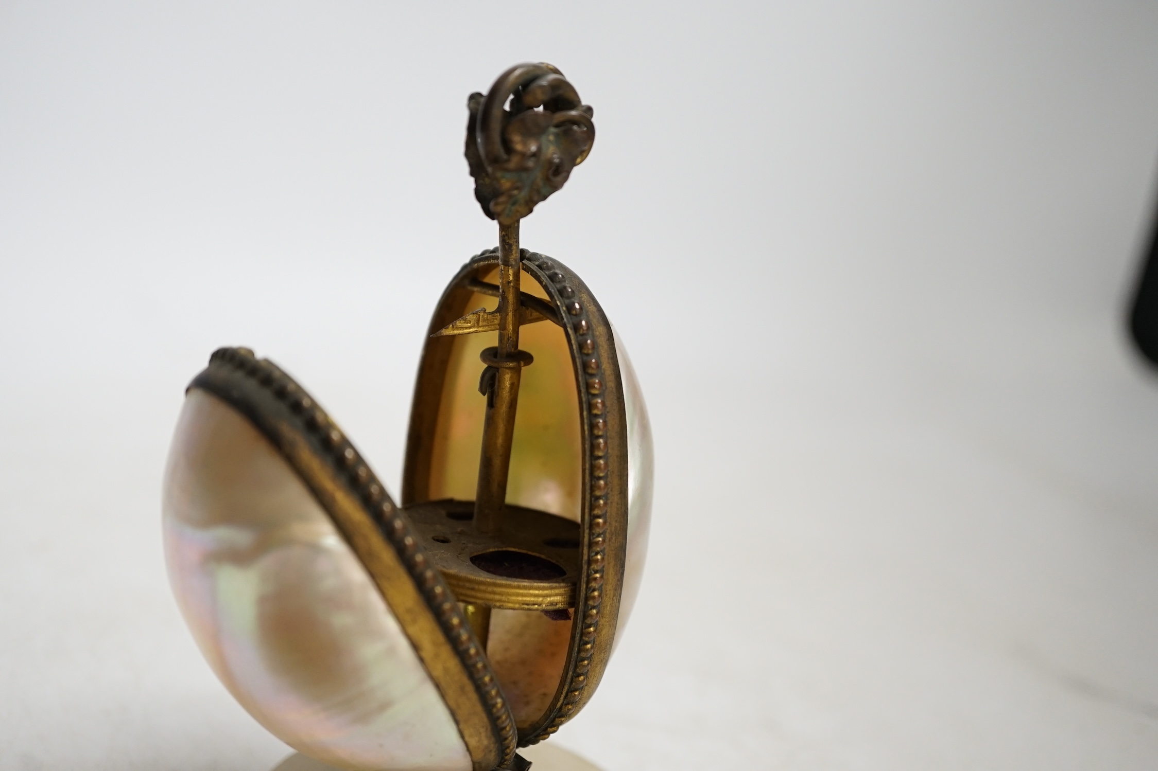 A Victorian tortoiseshell and silver piqué inlaid circular lidded snuff box and a Palais Royale mother-of-pearl and ormolu needlework case, largest 13cm high. Condition - fair, case does not snap shut